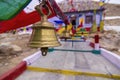 Hindu Religious prayer bell with Buddhist prayer flags in background, Ladakh,India