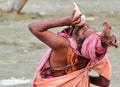 Hindu sadhu (saint) blowing conch.