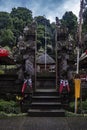 Guardians of a sacred temple gate in Penglipuran Traditional Village Bali Indonesia Royalty Free Stock Photo