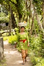 Hindu woman with a burden on his head, in - Nusa Penida, Indonesia