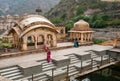 Hindu woman praying near the water tank of the 18th century temple