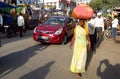 Hindu women dressed in colorful sari in India with huge bag on head