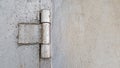 The hinge on an old rusty iron door is painted gray, close-up. garage door hinge. Copy space