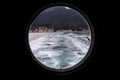 Hinged round window, storm cover on ship looking outside into Mediterranean sea. Porthole view through window on ship.