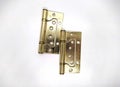 hinges for doors of gold color on a white background photo. Royalty Free Stock Photo