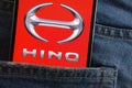 Hino logo displayed on smartphone hidden in jeans pocket