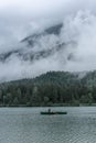 HINTERSEE, GERMANY, 3 AUGUST 2020: Lonely boat sailing in the foggy Intersee Lake in Bavaria