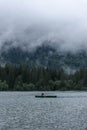 HINTERSEE, GERMANY, 3 AUGUST 2020: Lonely boat sailing in the foggy Intersee Lake in Bavaria