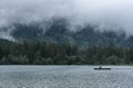 HINTERSEE, GERMANY, 3 AUGUST 2020: Lonely boat sailing in the foggy Intersee Lake in Bavaria