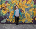 Hip eleven year old girl in front of a garage door mural in South Philadelphia