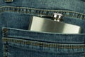 Hip flask in pants pocket, blue jeans