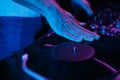 Hip hop disc jockey scratches vinyl record on turn table player. Club dj scratching records on turntables Royalty Free Stock Photo