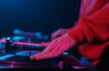 Hip hop DJ scratches record on turn table. Hand of a disc jockey scratching vinyl disc in close up