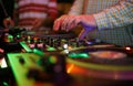 Hip hop dj scratches records and plays music on hip hop party in nightclub. Professional disc jokey mixing records on turntables.
