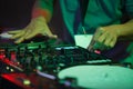 Hip hop dj scratches vinyl records on party in night club. Hands of professional disc jockey scratching record on turntable player Royalty Free Stock Photo