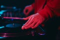 Hip hop dj scratching vinyl disc with music on deck. Club disc jockey scratches a record on turntable player Royalty Free Stock Photo