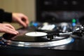 Hip hop dj scratching vinyl record disc on turn table player in close up