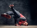 Hip-hop style dancer performs breakdance acrobatic elements. Royalty Free Stock Photo