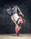 Hip-hop style dancer performs breakdance acrobatic elements. Royalty Free Stock Photo