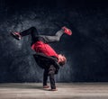 Hip-hop style dancer performs breakdance acrobatic elements. Royalty Free Stock Photo