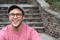 Hip man smiling wearing eyeglasses and hat Royalty Free Stock Photo