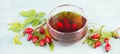 Hip rose tea with fresh fruits and leaves, hot drink Royalty Free Stock Photo