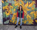 Hip sixteen year old girl in front of a garage door mural in South Philadelphia