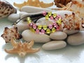 Colorful friendship bracelet on sea pebble