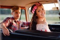 Hippie couple in a van on a road trip