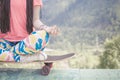 Hippie fashion girl doing yoga, relaxing on skateboard at mountain Royalty Free Stock Photo