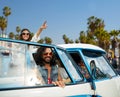 Hippie friends in minivan car at venice beach Royalty Free Stock Photo