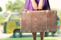 Hippie girl with old suitcase