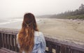 Hippie girl with red braided hair looking at Long Beach near Tofino at sunrise Royalty Free Stock Photo