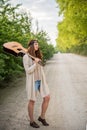 Hippie girl standing on the road with a guitar Royalty Free Stock Photo