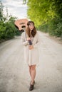 Hippie girl walking on the road with a guitar Royalty Free Stock Photo