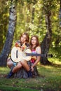 Hippie girls with guitar outdoor