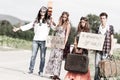 Hippie Group Hitchhiking on a Countryside Road Royalty Free Stock Photo