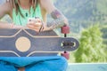 Hippie handsome man with skateboard and mobilephone listening to music Royalty Free Stock Photo