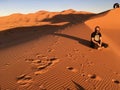 Hippie Men sitting in the Sahara Desert, somewhere in Morocco