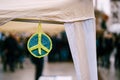 A hippie sign. The symbol of peace is bound from threads. Homemade peace symbol made of yarn