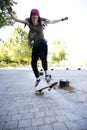 Hippie woman jumping from the skateboard