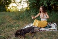 A hippie woman playing in nature with her little dog Royalty Free Stock Photo