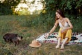 A hippie woman playing in nature with her little dog Royalty Free Stock Photo