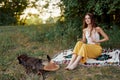 A hippie woman playing in nature with her little dog Royalty Free Stock Photo