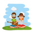 Hippies couple playing guitar in the field