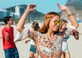 Hippy girl with group of man and woman at open air festival