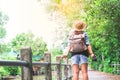 Hipster asian girl with camera breathing and looking at tropical walkway and canal, Tourist Traveler in Asia