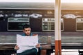 Hipster asian man looking on map paper seaching to location. Royalty Free Stock Photo