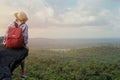Hipster asian young girl with backpack enjoying sunset on peak mountain. Travel Lifestyle adventure concept