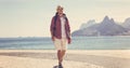 Hipster backpacker tourist walking at Ipanema beach at Rio de Janeiro